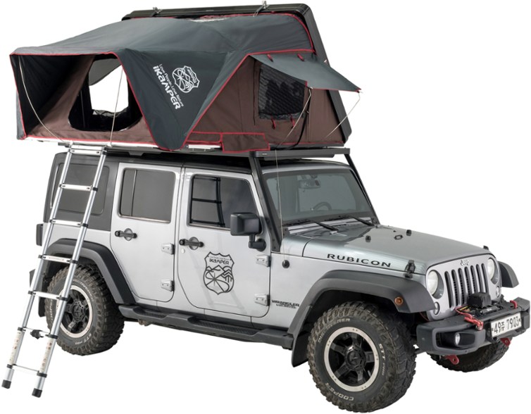 A jeep camper setup on top of a white jeep with a ladder leading to it 