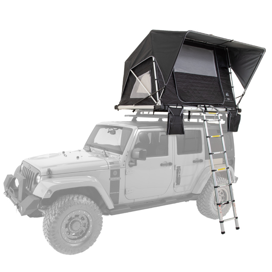 A jeep with a pop up camper setup on the roof 