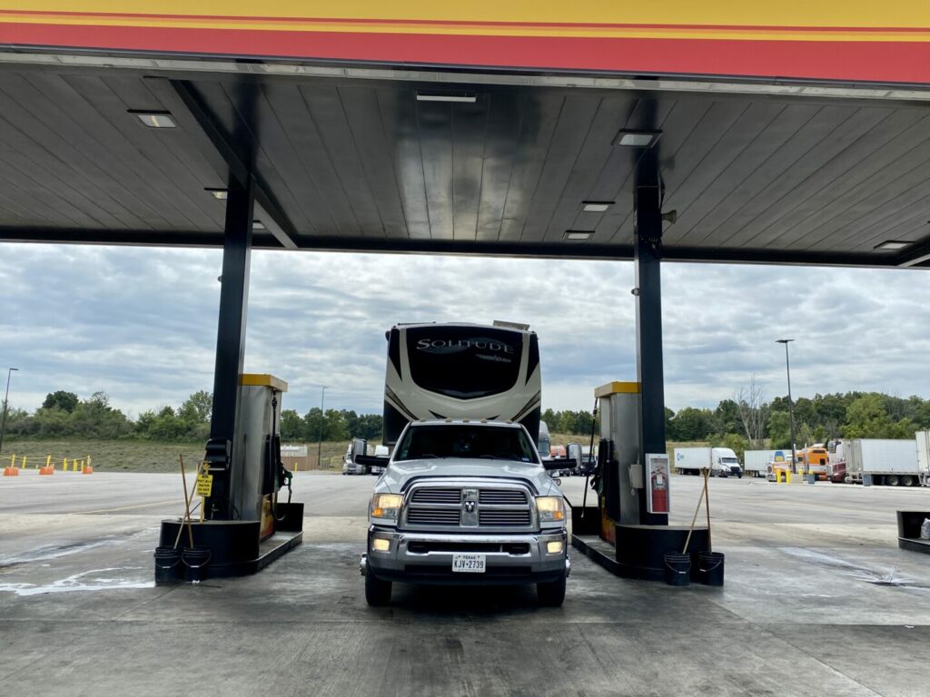 A truck towing a fifth wheel parked at a truck stop using their TSD fuel card 