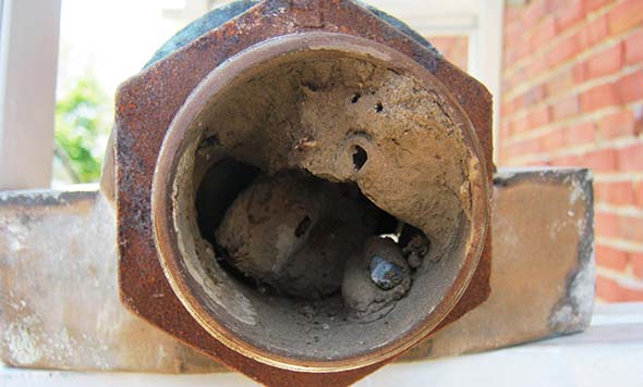 Intake vent RV furnace blocked with dirt dauber nest of mud