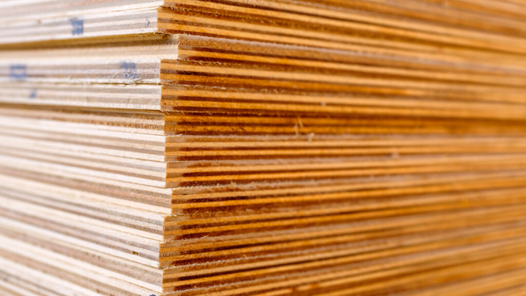 A stack of plywood ready to put hard sides on a pop-up camper.