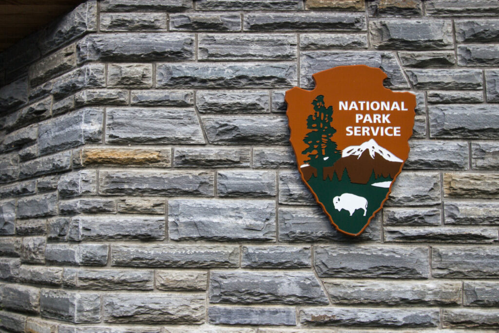 A National Park Service sign on a brick building 