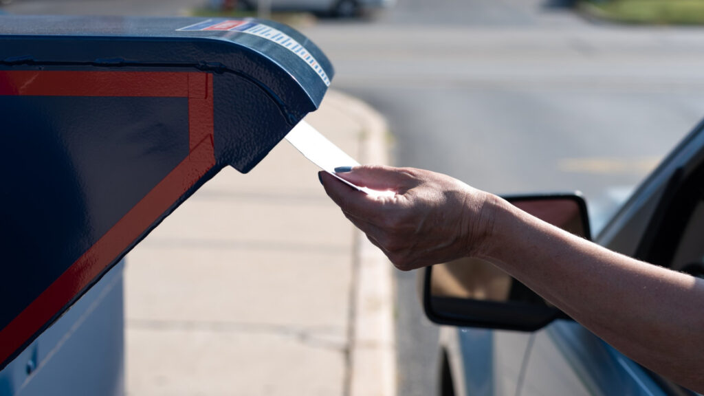 A driver dropping off their mail at a postal service, an option to get your mail with Americas Mailbox.