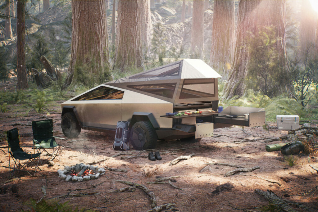 Tesla stock image of their electric RV Cybertruck out in the woods with a campfire and tent set up 