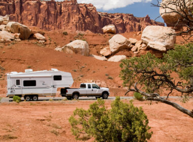 An RV attached to a truck in the mountains using a 5th wheel hitch installation.