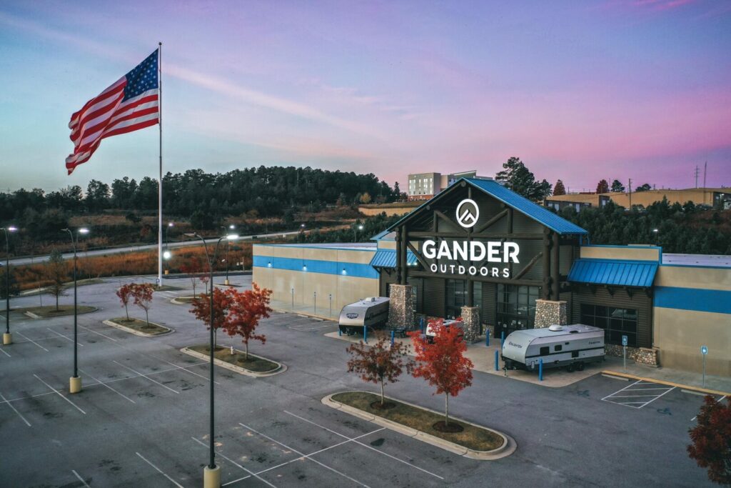 Gander RV building at sunset with their giant US flag waving in the parking lot 
