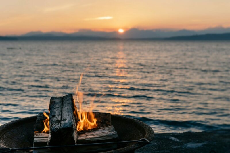 A firepit going at a beach campground.