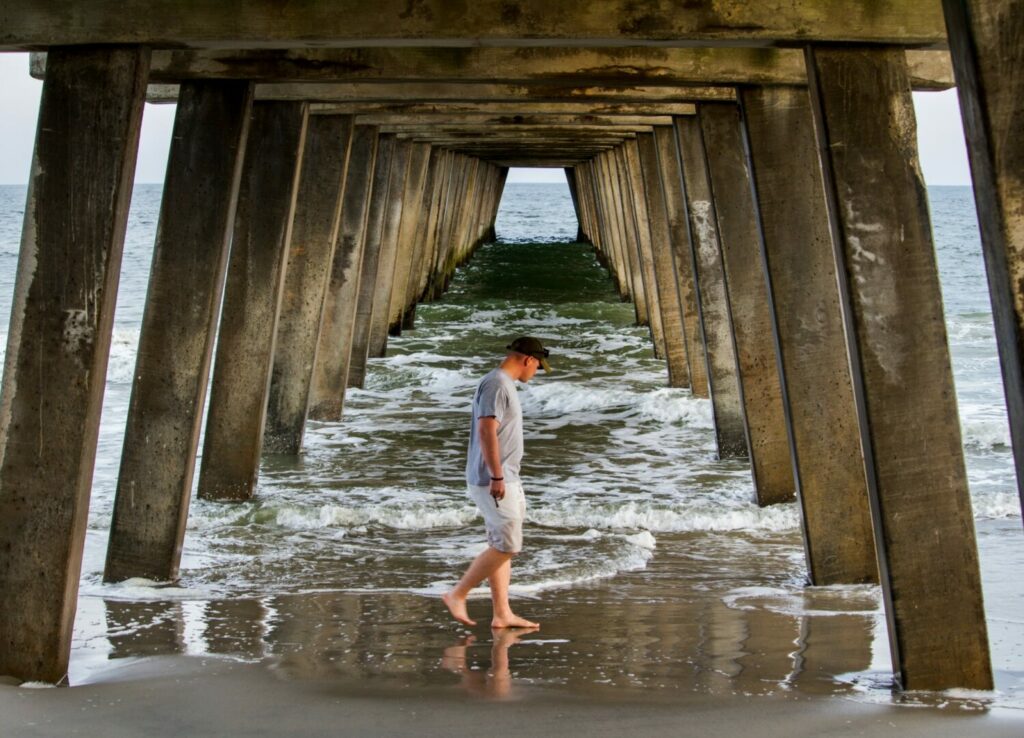 A man walking at Tybee Island, 20 minutes away from his beach campground.