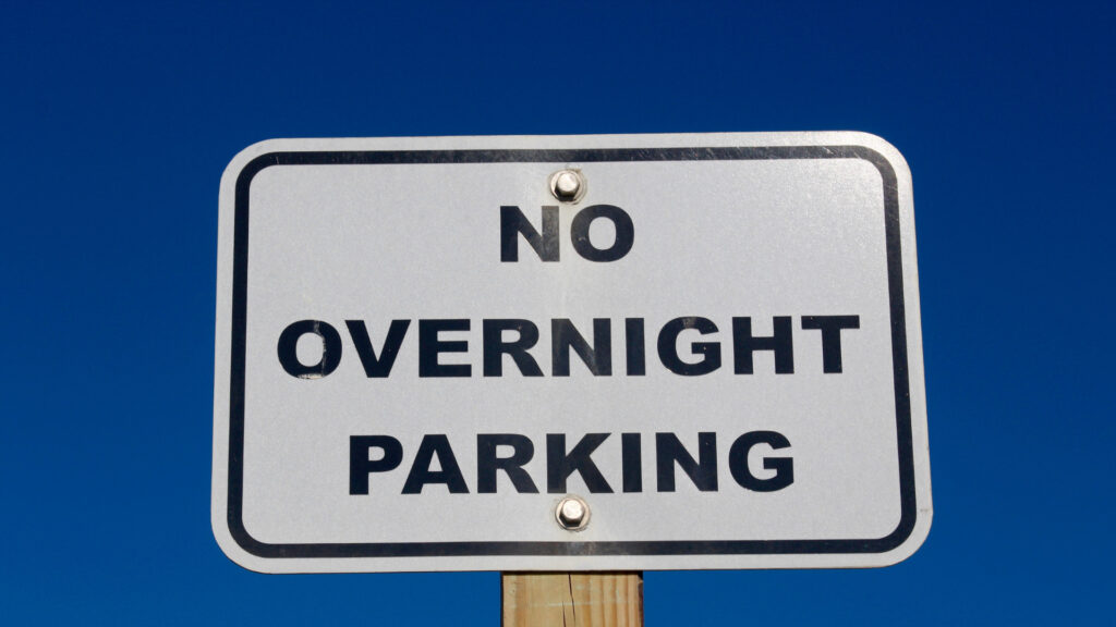 A no overnight parking sign.