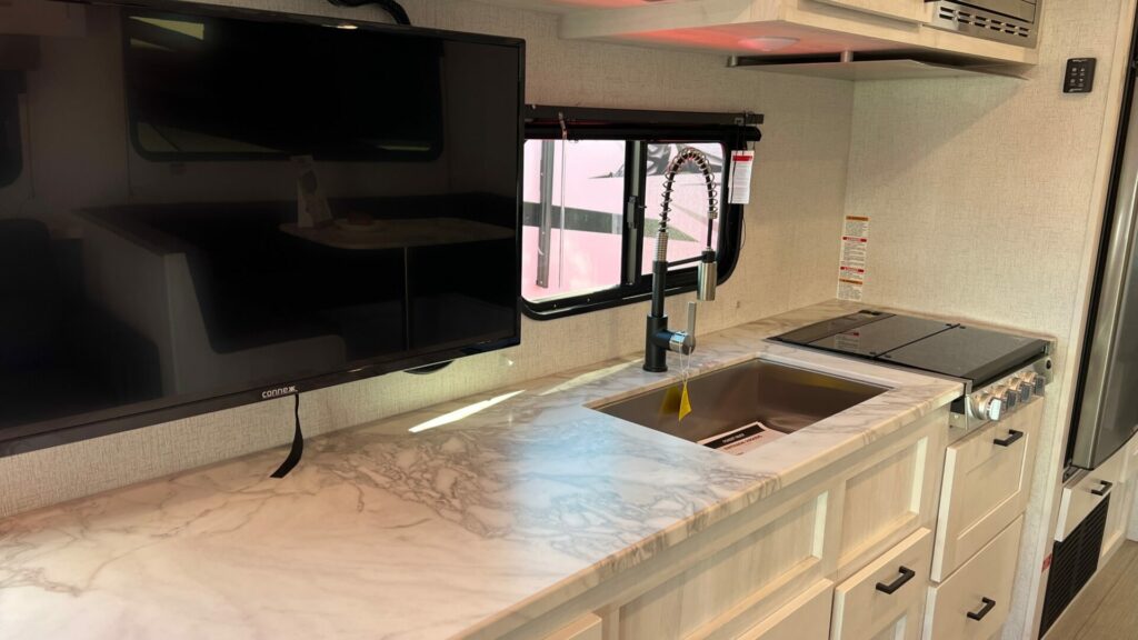 Interior picture of an r-pod camper kitchen and TV
