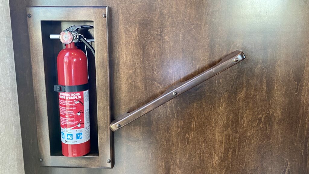 A fire extinguisher in an RV. When dewinterizing an RV it's a good idea to check your safety equipment. 
