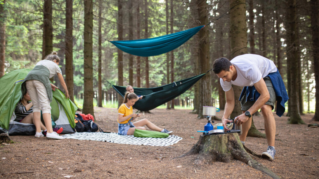 A family camping on their outdoor camping rugs.
