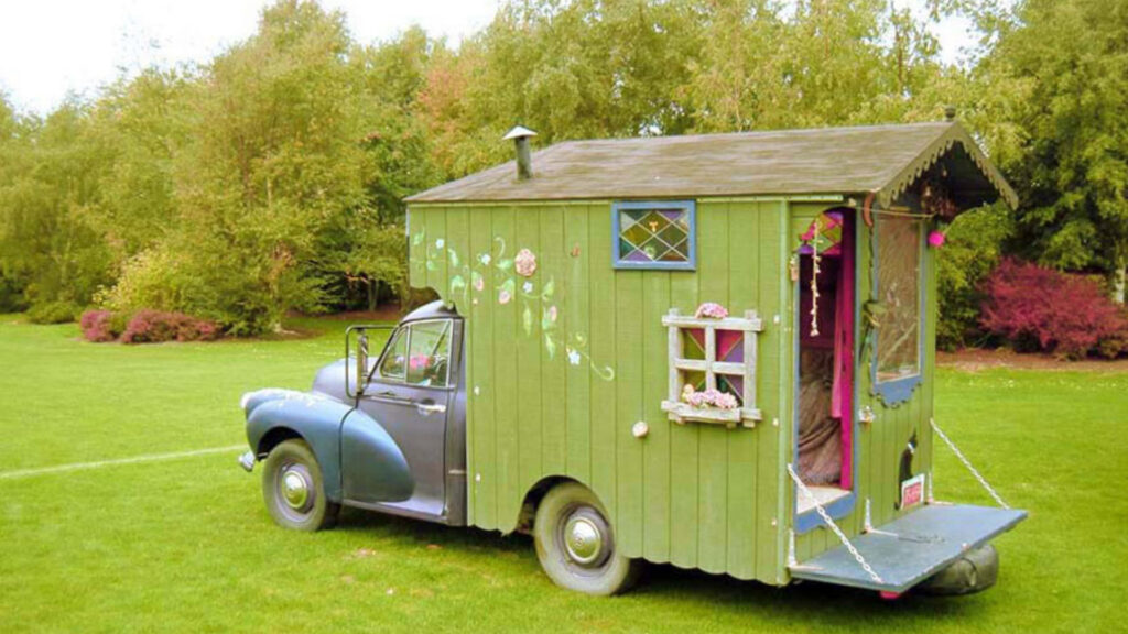 A small green house truck.