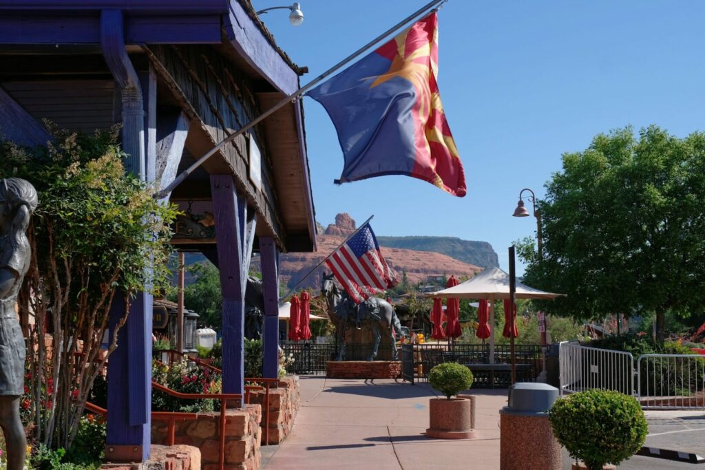 Flags flapping in the wind at the front entrance of Rancho Sedona RV Park