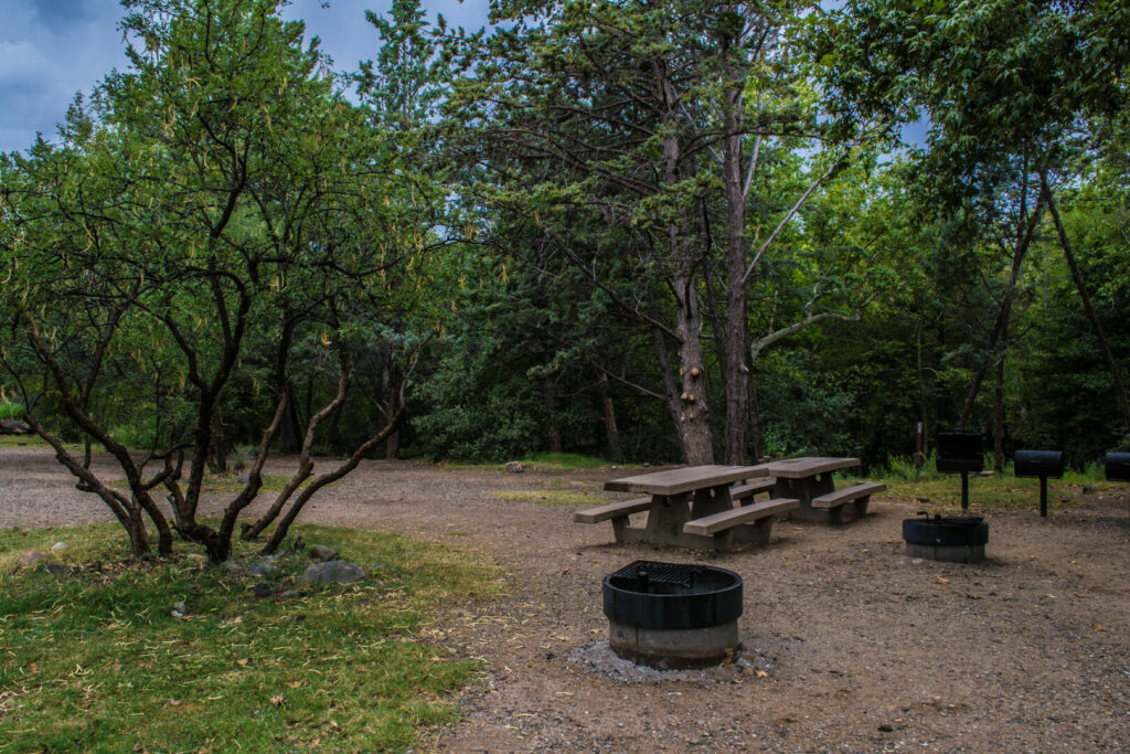 Picnic tables and fire pits of the Chavez Crossing Group Campground