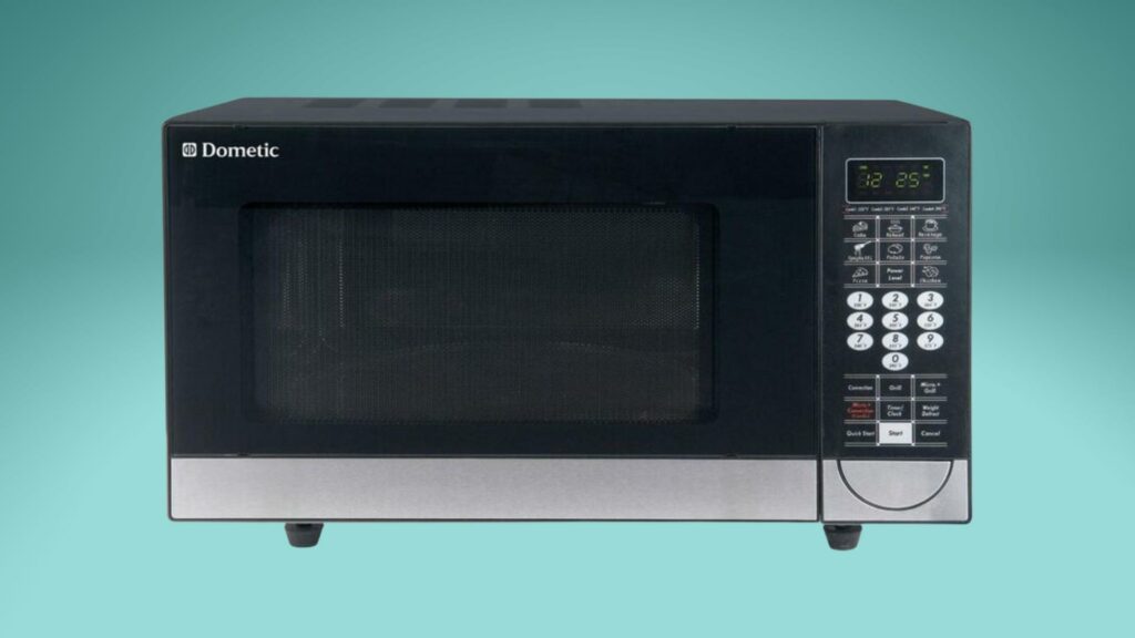 A Dometic brand RV microwave on a green background