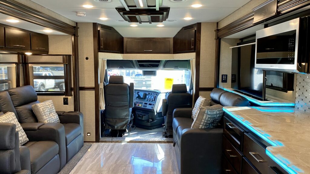 Interior shot of an RV showing different products in the kitchen and living room 