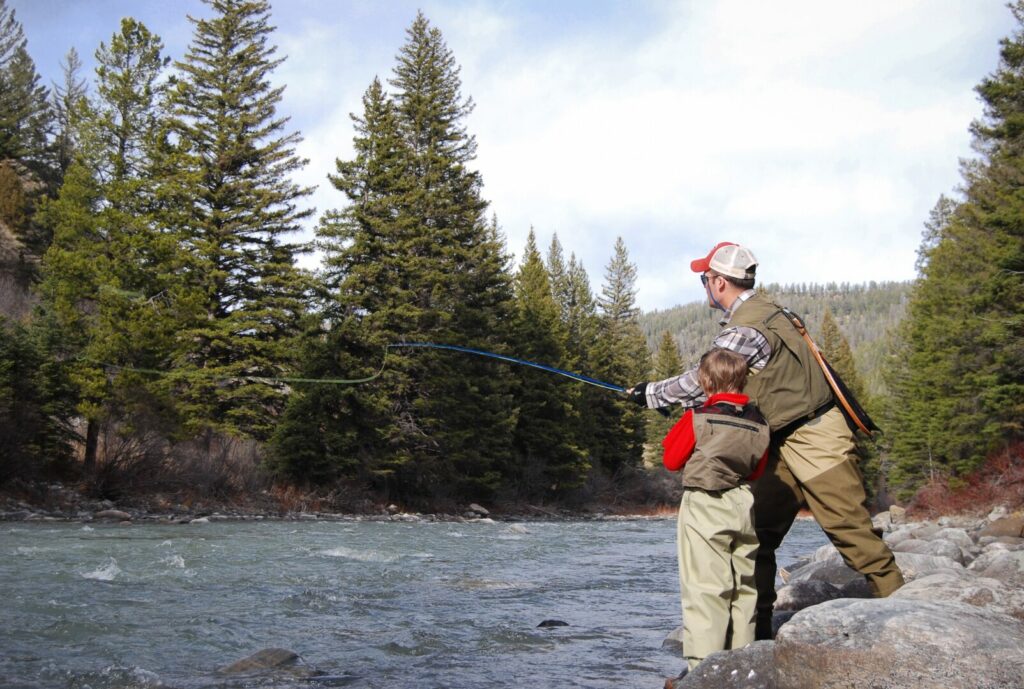 A father and son duo fishing in a river