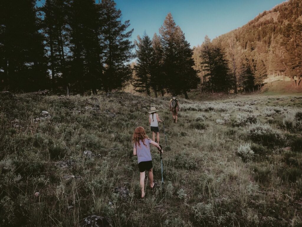 Family hiking up a hill in beautiful Montana