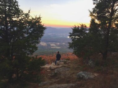 A man sunset watching at Mount Magazine Park in Arkansas, one of the many state parks