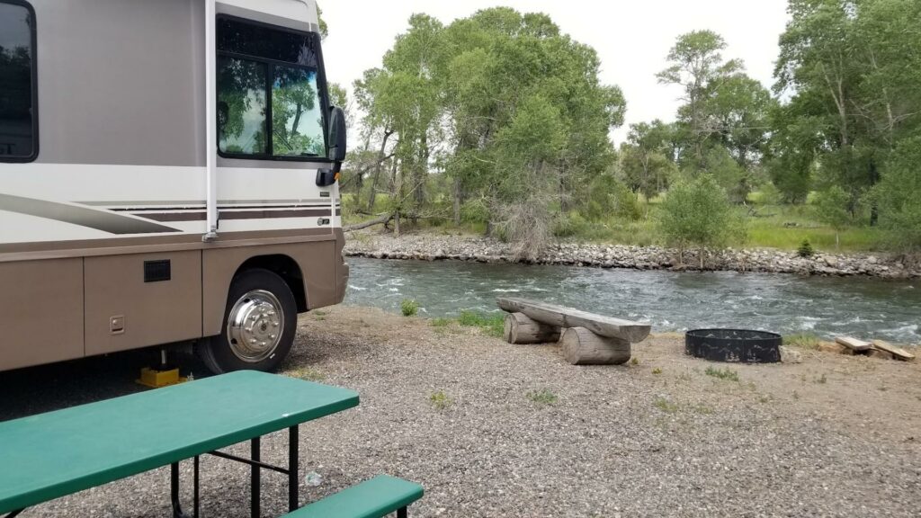 A Class A RV parked along a river at one of the popular Montana RV parks 