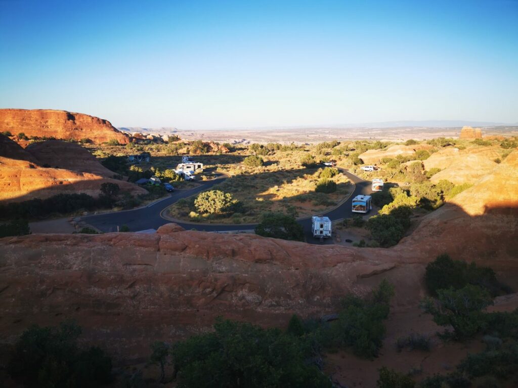 A far away shot of Devil's Garden Campground in Arches National Park showing it full of small RVs. This is one of the best campgrounds moab utah. 