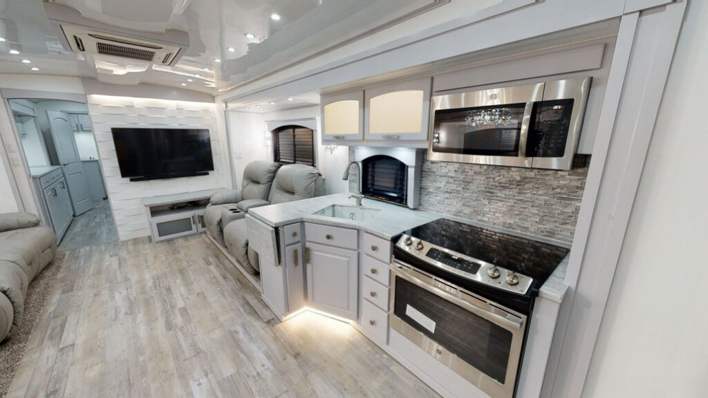 Interior picture of a SpaceCraft RV showing the kitchen, living room, and hallway to bedroom
