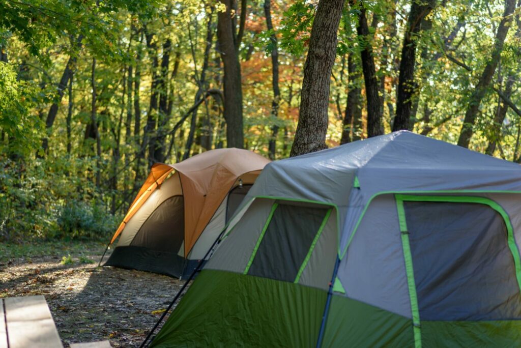 Tents closely together at a packed campground site, a foolproof way to ruin a camping trip.