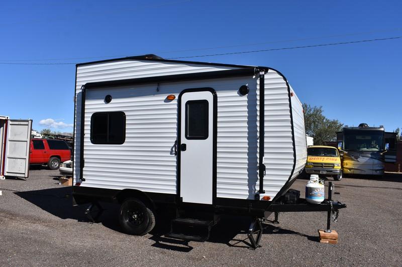 The Dune Sport Firestorm MM Mini small toy hauler in white sitting on a paved lot 