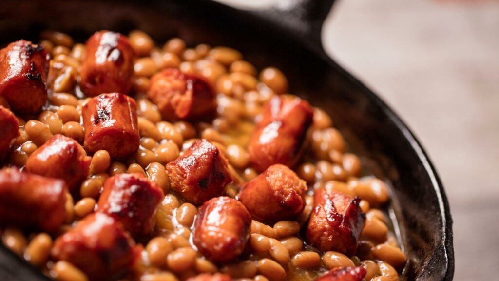 Frank and beans in a cast iron pan, one of our camping food favorites.