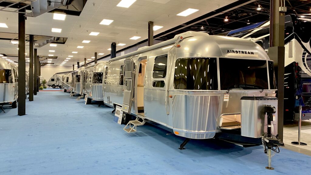 A row of Airstream trailers at an RV show 