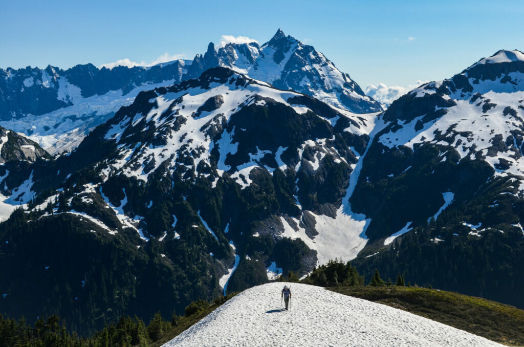 A man hiking at North Cascades National Park, one of the least visited national parks