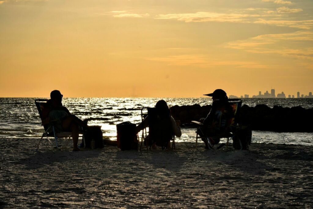 Group of friends at the beach in St. Petersburg by their koa campground in Florida.