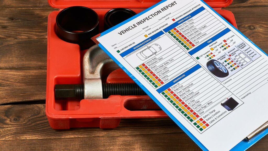 Vehicle inspection checklist sitting on a pile of tools
