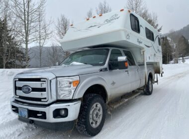 Bigfoot truck camper parked in the snow