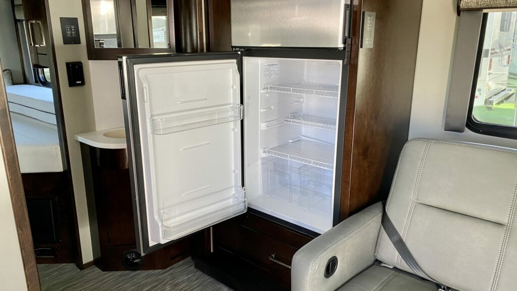 A 3-way RV fridge with the door open in a new RV