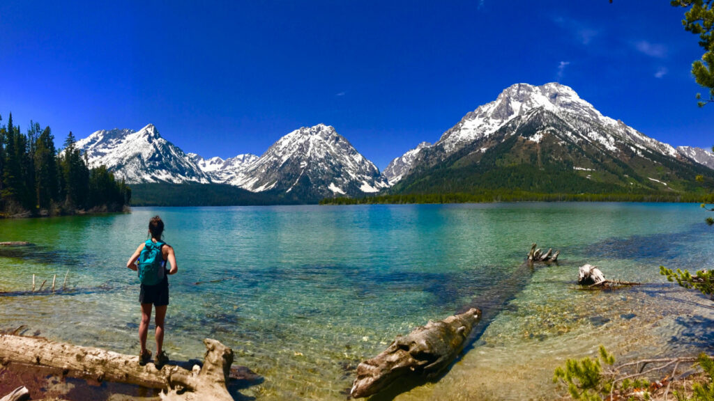A woman standing at Grant Teton, one of the best national parks in usa