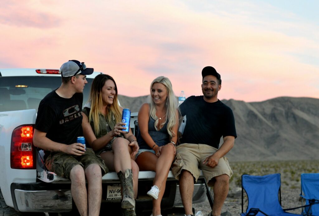 A group of friends partying on their truck while out camping, which is a popular but different type of RVer you may see.