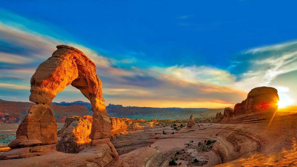 Arches National Park at sunrise with two famous arches lit up 