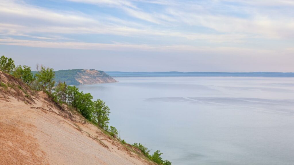Standing at the top of a dune at Sleeping Bear Dunes National Lakeshore looking over Lake Michigan 