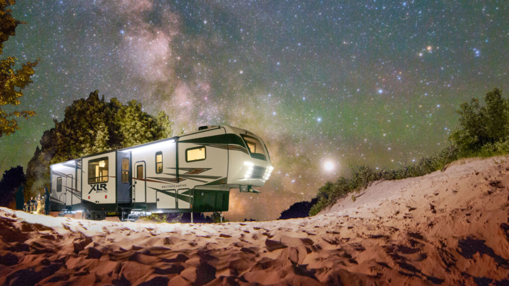 The Nitro XLR toy hauler outside at night by the stars