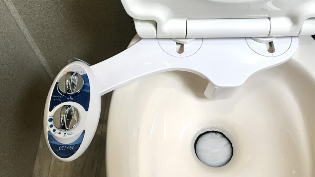 A toilet in an RV with a Neo 120 RV bidet installed on it 