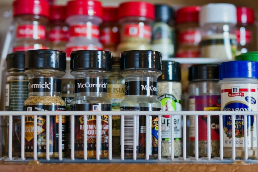 Spices in a kitchen cabinet spice rack, one of the useful camper accessories for inside the RV.