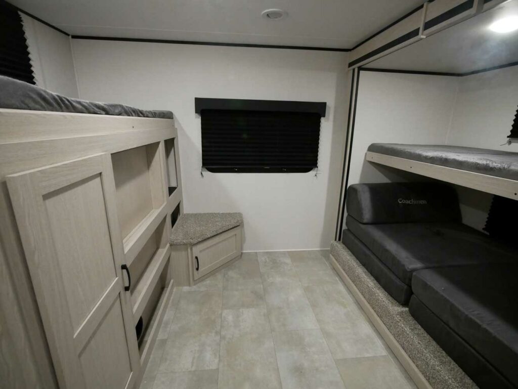 This Coachmen Apex Ultra Lite 300BHS travel trailer has a bunkhouse inside for larger families