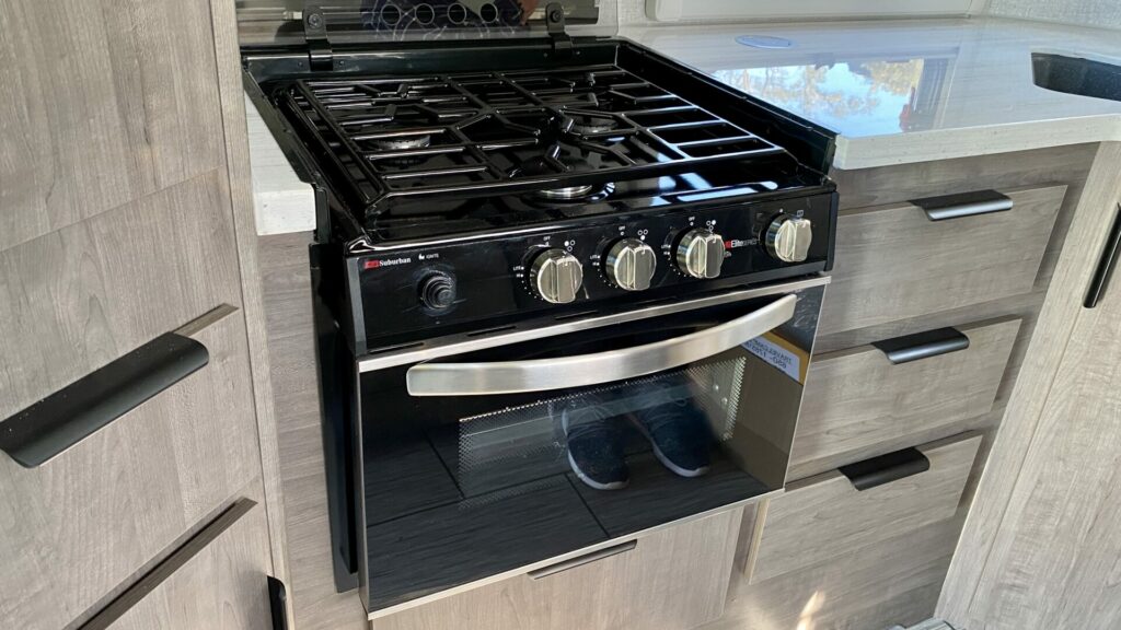 A stove in a new RV with three burners
