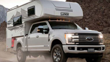 A lance 650 truck camper outside attached to a truck