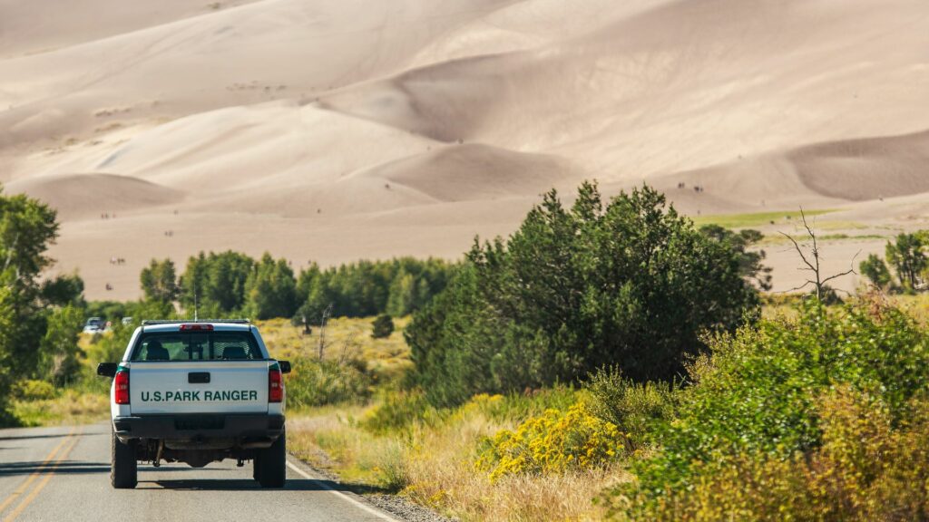 A US Park Ranger truck driving down the road in a National Park 