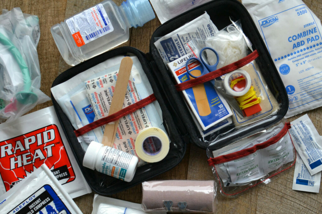 View of a first aid kit and survival tools for a camping trip
