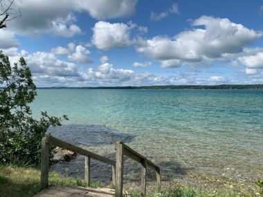 Stairs leading down to torch lake in Michigan