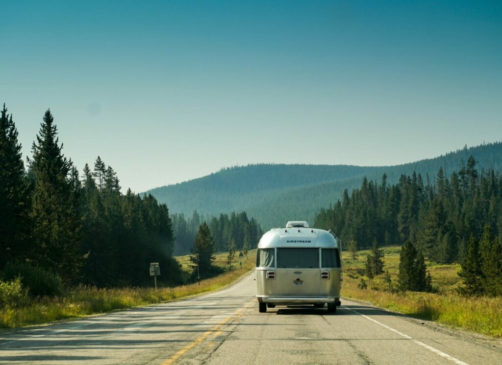 An Airstream RV driving on the highway across Texas